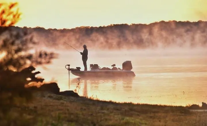 Angler on bass boat at sunrise in Indiana