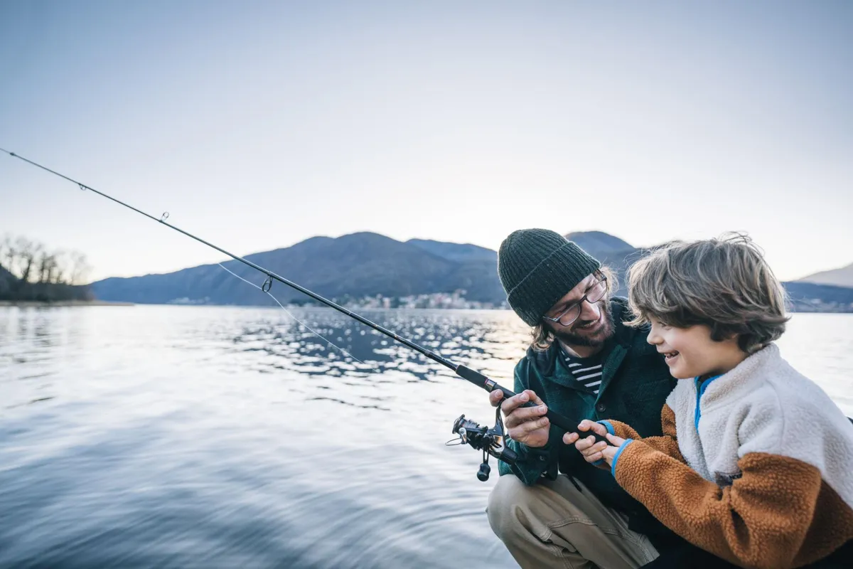 Father and son fishing on a lake